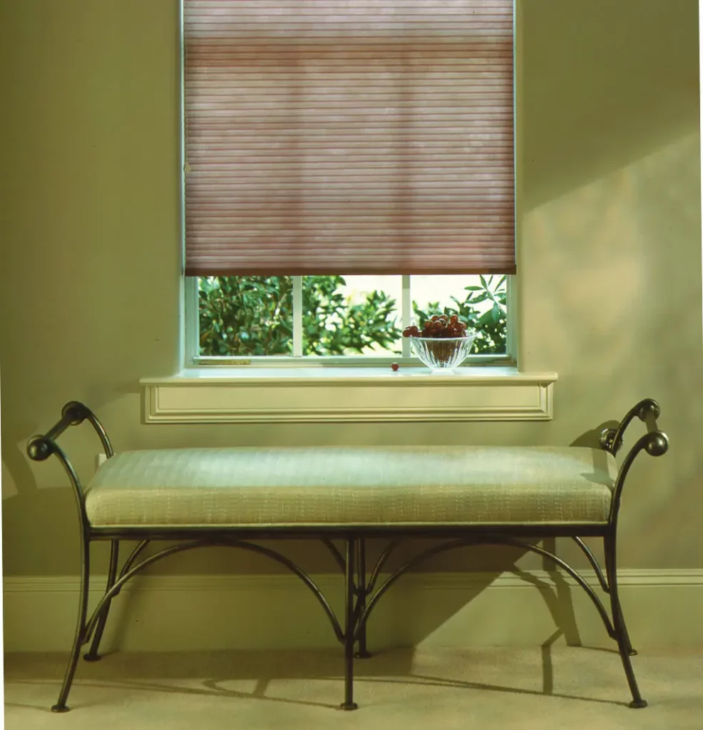 Honeycomb_039-opti Brown honeycomb window blinds covering the window of a green themed room.