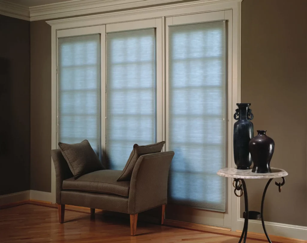 Honeycomb_048-opti Three windows in a room conveniently covered by tailor made white honeycomb blinds, also known as cellular blinds.