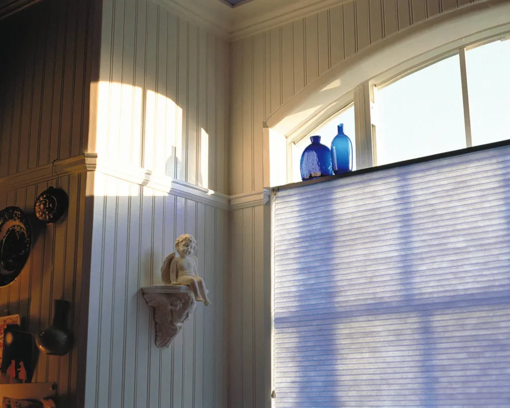 Honeycomb_059-opti Beautiful blue colored honeycomb shades designed to allow the right amount of light into the room.