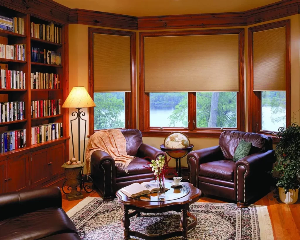 Wholesale-Blind-Factory-Shades-Cellular-Shades_AC-opti Elegant set of honeycomb window blinds cover a home library's windows