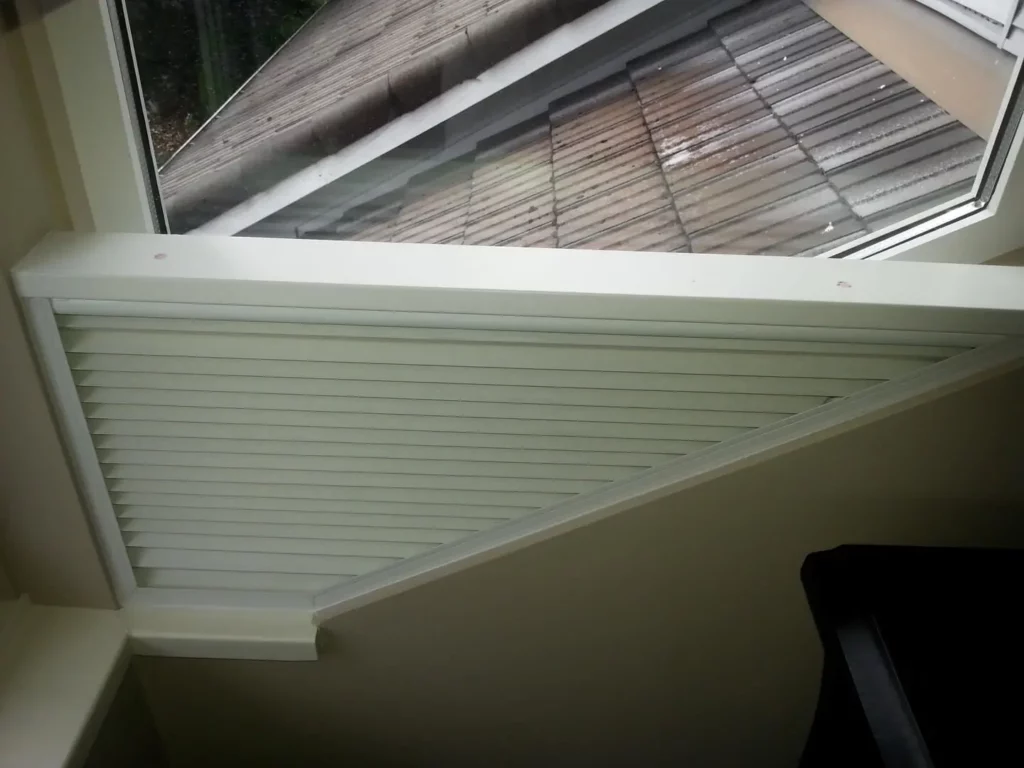 Custom blinds made to fit a staircase window, showing how custom shades can be work independently