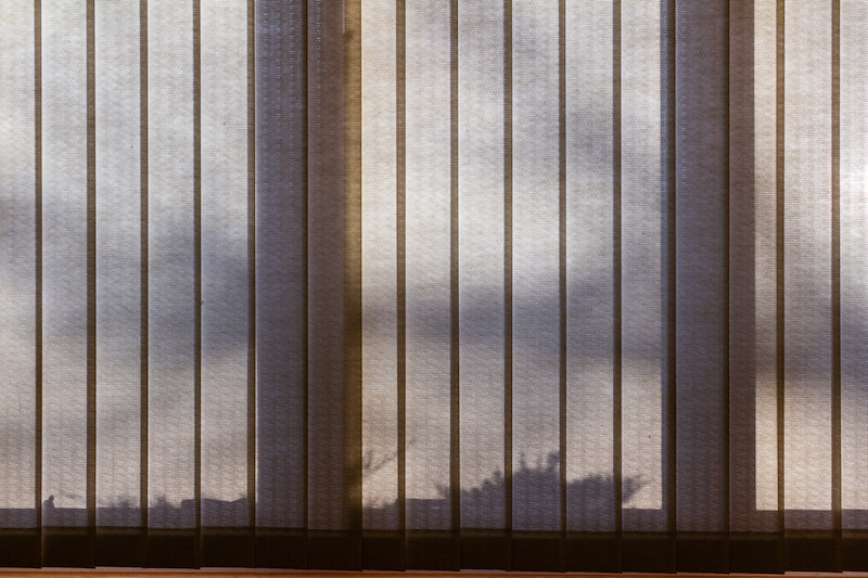 shadows behind sheer vertical blinds